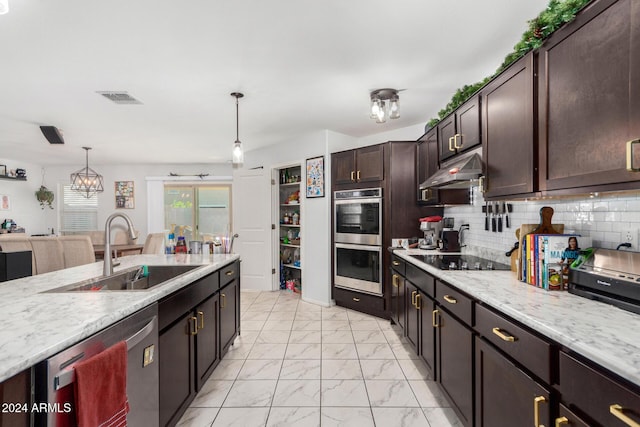 kitchen with decorative light fixtures, stainless steel appliances, dark brown cabinets, and sink