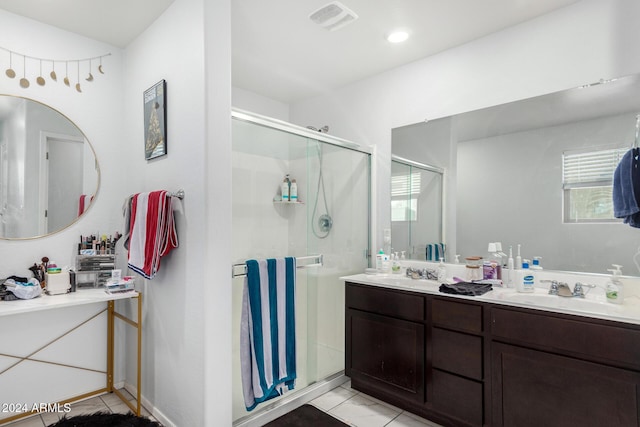 bathroom featuring tile patterned floors, vanity, and an enclosed shower