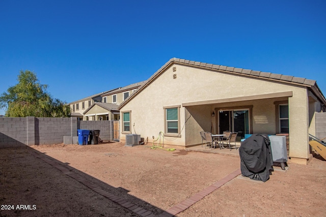 back of property featuring central AC unit and a patio area