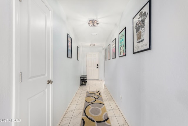 corridor featuring light tile patterned floors