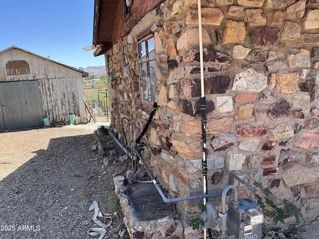 829 W Spray St, Superior, AZ 85173 - exterior view of stone siding, gas meter, and a pole building