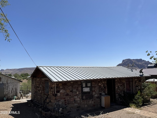 829 W Spray St, Superior, AZ 85173 - view of home's exterior featuring stone siding, metal roof, and a mountain view