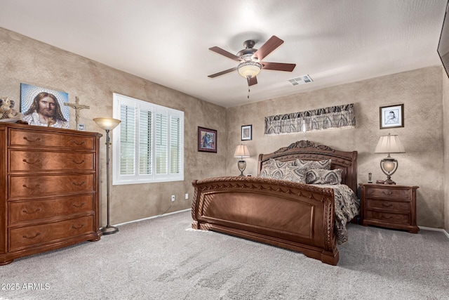 bedroom with carpet, visible vents, and ceiling fan