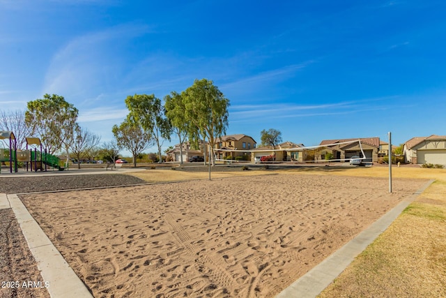 view of property's community with a residential view, playground community, and volleyball court