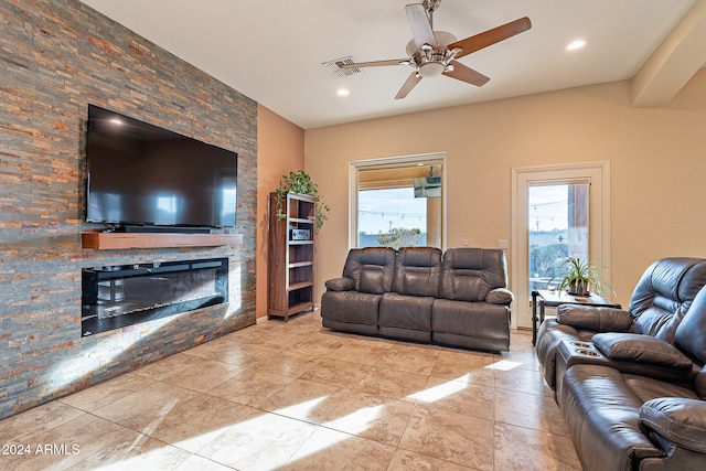 living room featuring a fireplace and ceiling fan