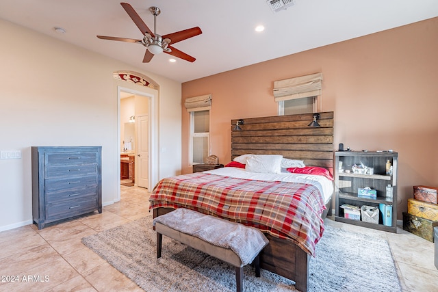 bedroom featuring connected bathroom, ceiling fan, and light tile patterned floors