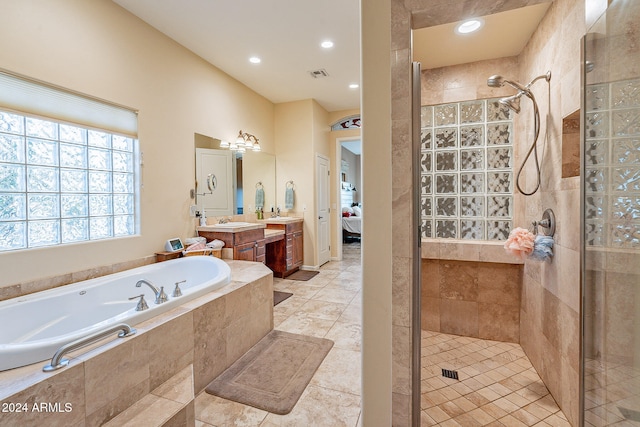 bathroom featuring vanity, tile patterned floors, and plus walk in shower