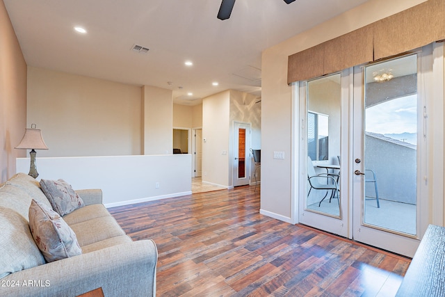 living room featuring ceiling fan and hardwood / wood-style floors