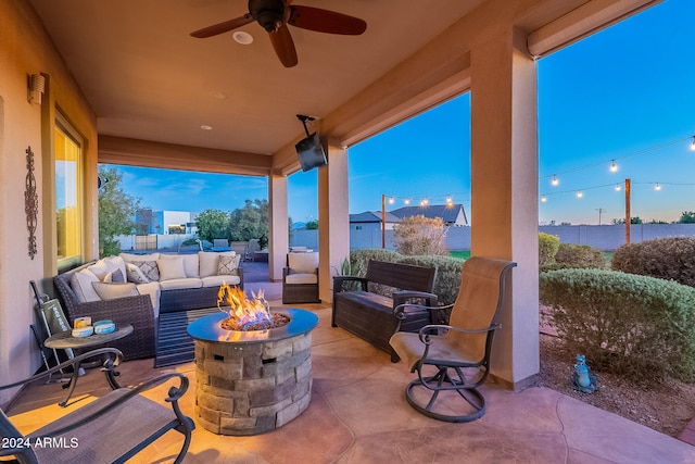 view of patio / terrace featuring ceiling fan and an outdoor living space with a fire pit