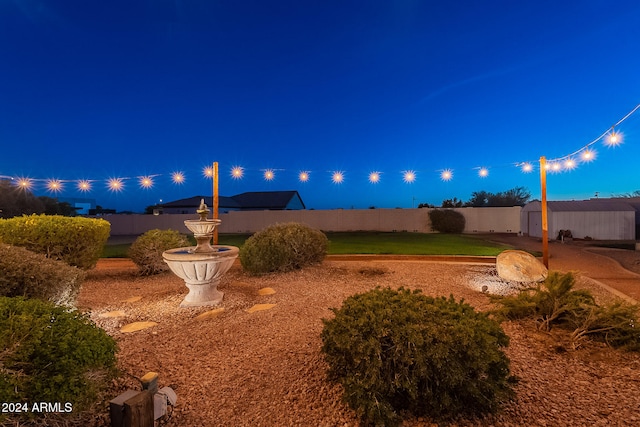 view of yard at twilight