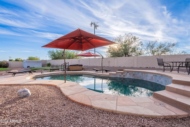 view of swimming pool with a patio and a hot tub