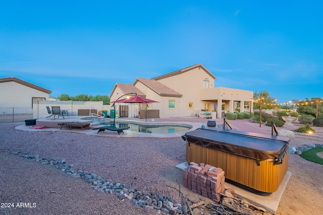 view of pool with a hot tub and a patio area