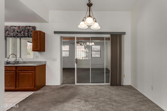 1501 E Colonial Dr, Chandler, AZ 85249 - unfurnished dining area with light colored carpet, a sink, and an inviting chandelier