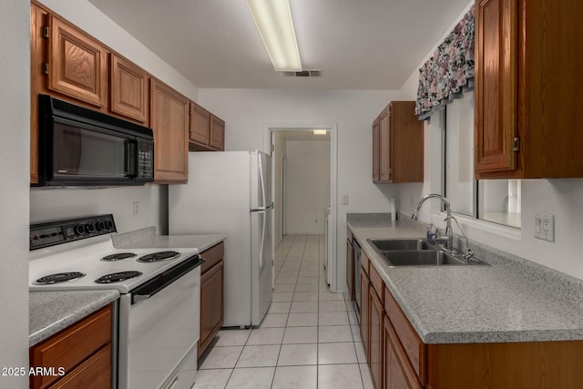 1501 E Colonial Dr, Chandler, AZ 85249 - kitchen featuring a sink, visible vents, white appliances, brown cabinetry, and light tile patterned floors