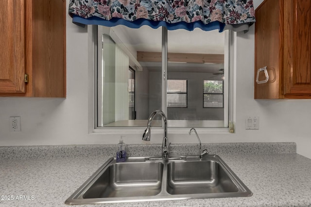 1501 E Colonial Dr, Chandler, AZ 85249 - kitchen featuring brown cabinetry, a sink, and light countertops