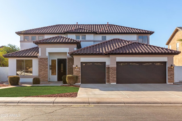 mediterranean / spanish-style house with a garage