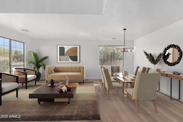 living room featuring light wood-type flooring and an inviting chandelier