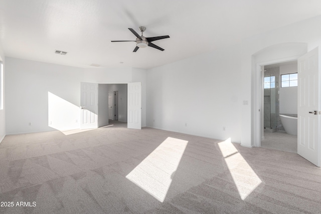 unfurnished room with ceiling fan and light carpet