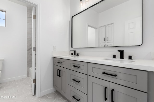 bathroom with tile patterned flooring, vanity, and toilet