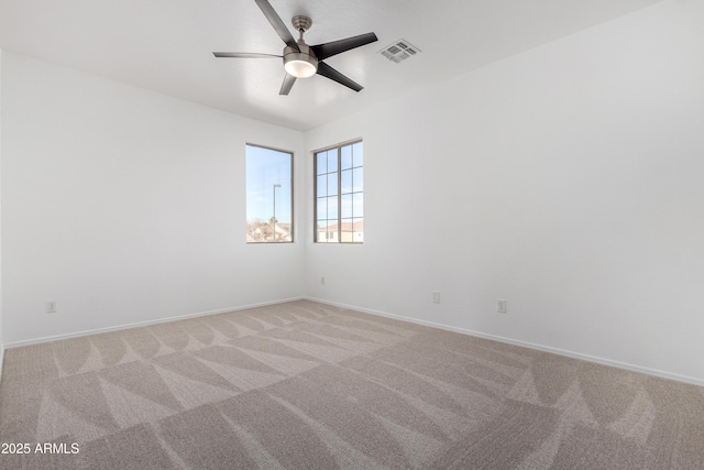 empty room featuring ceiling fan and light carpet