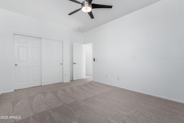 unfurnished bedroom featuring ceiling fan, light carpet, and a closet