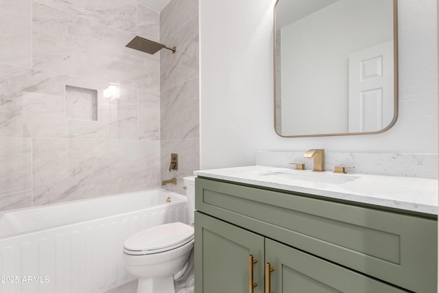 full bathroom with vanity, tiled shower / bath combo, and toilet