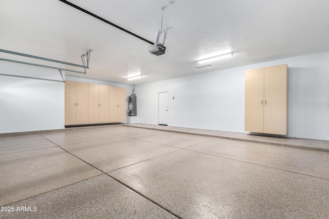 garage featuring water heater and a garage door opener