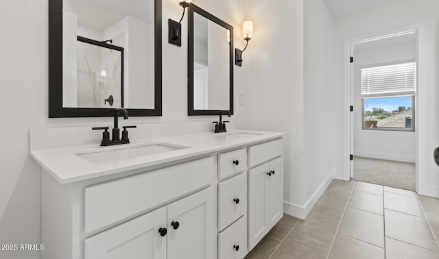 7416 S 76th Ln, Laveen, AZ 85339 - bathroom with double vanity, baseboards, a shower with door, and tile patterned floors