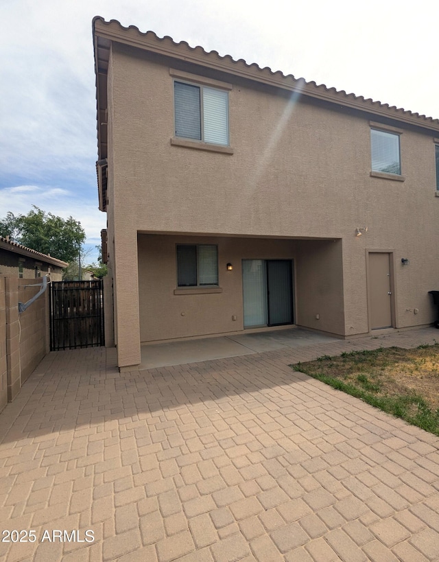 15446 W Jenan Dr, Surprise, AZ 85379 - back of property featuring a patio, stucco siding, and fence