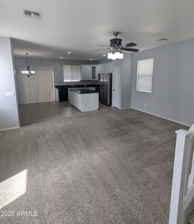 15446 W Jenan Dr, Surprise, AZ 85379 - kitchen with open floor plan, stainless steel fridge, dark countertops, a chandelier, and recessed lighting
