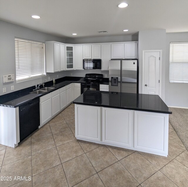 15446 W Jenan Dr, Surprise, AZ 85379 - kitchen with black appliances, a sink, white cabinets, dark countertops, and light tile patterned flooring