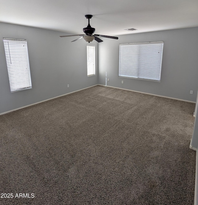 15446 W Jenan Dr, Surprise, AZ 85379 - spare room with a ceiling fan, carpet floors, and baseboards
