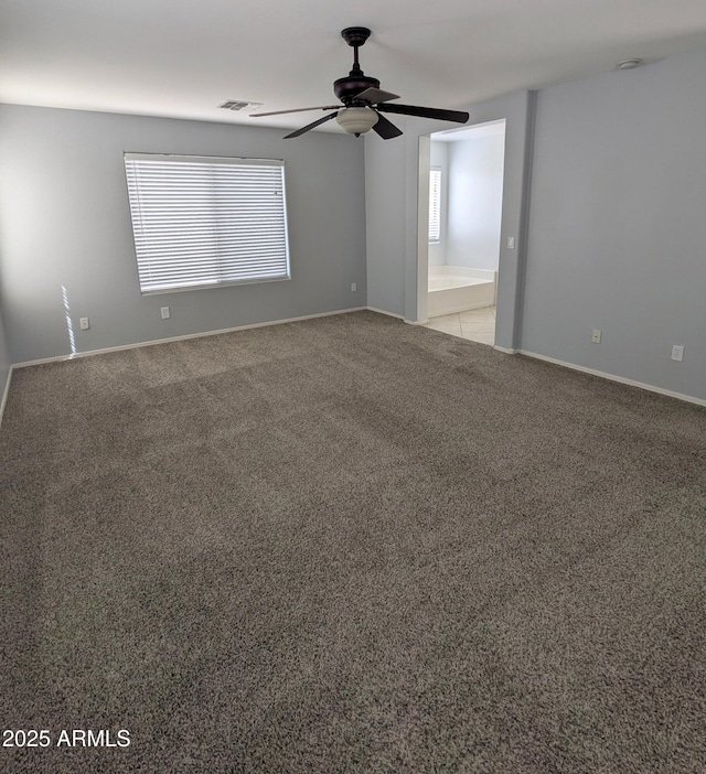 15446 W Jenan Dr, Surprise, AZ 85379 - unfurnished room with a ceiling fan, light carpet, healthy amount of natural light, and baseboards
