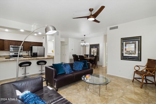 living room featuring ceiling fan with notable chandelier