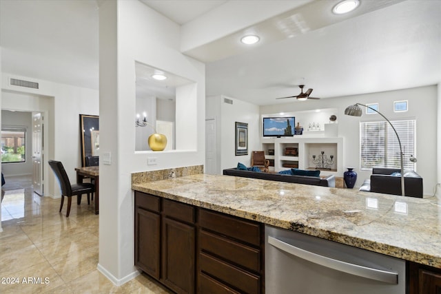 kitchen featuring ceiling fan, dark brown cabinets, and light stone countertops