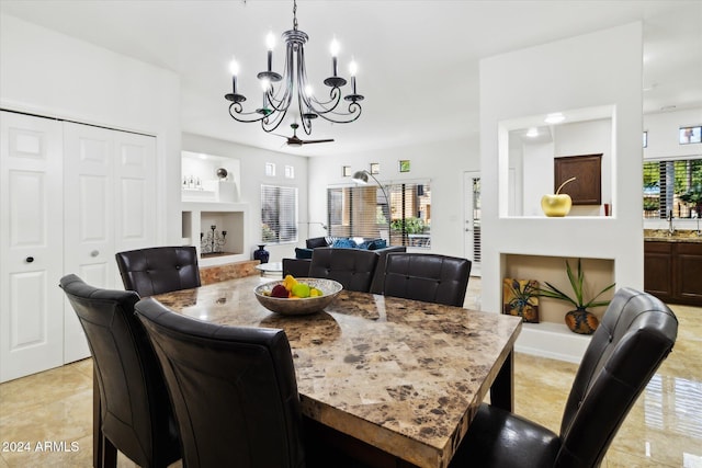 dining space featuring a notable chandelier, light tile patterned flooring, and sink