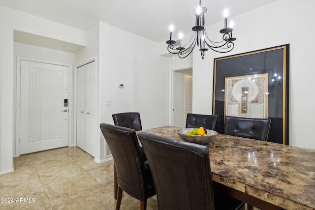 dining area with a notable chandelier and light tile patterned flooring