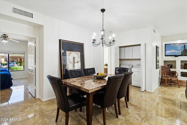 dining room featuring ceiling fan with notable chandelier and washing machine and dryer