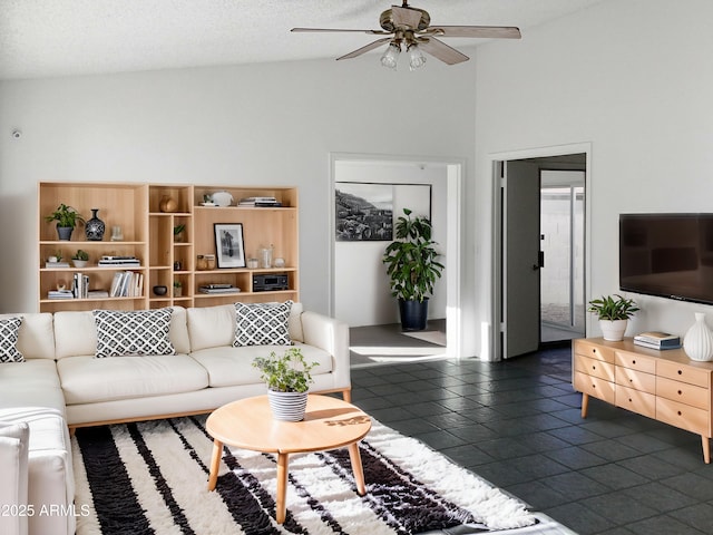 living room with a textured ceiling, high vaulted ceiling, and ceiling fan