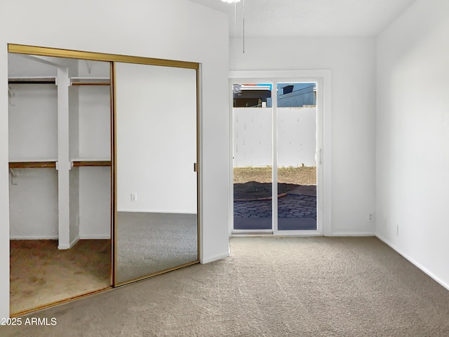 unfurnished bedroom with a closet and carpet