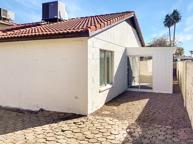 view of side of home featuring central air condition unit and a patio area