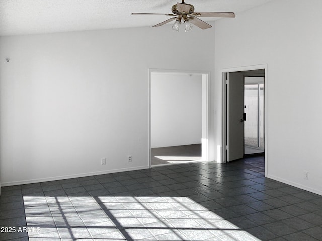 tiled empty room with ceiling fan, high vaulted ceiling, and a textured ceiling