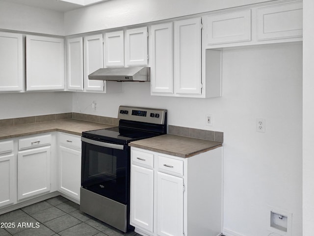 kitchen featuring white cabinetry, stainless steel electric range, and tile patterned flooring