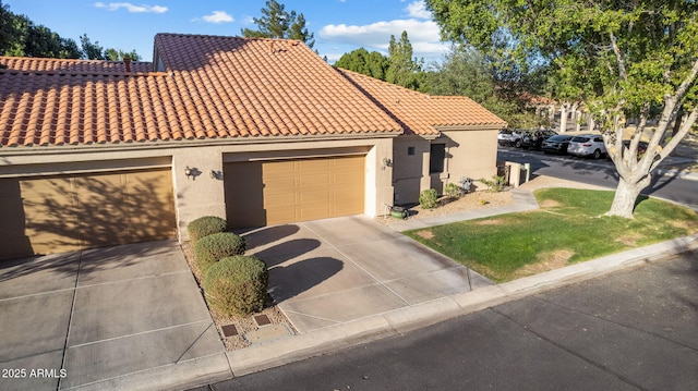 mediterranean / spanish-style home with a garage