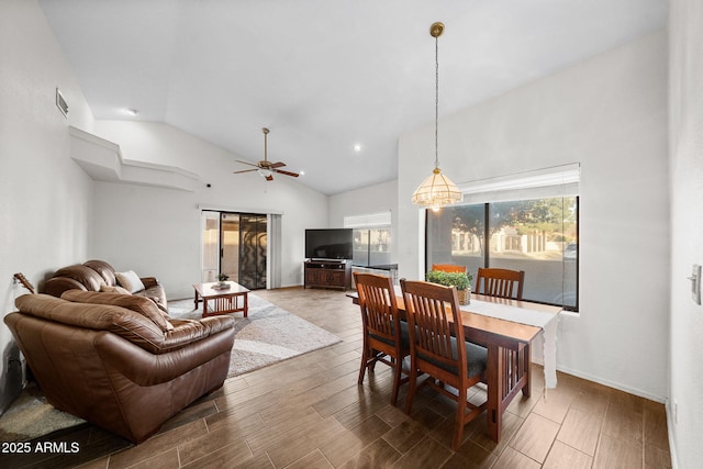 dining room with hardwood / wood-style flooring, ceiling fan, and vaulted ceiling