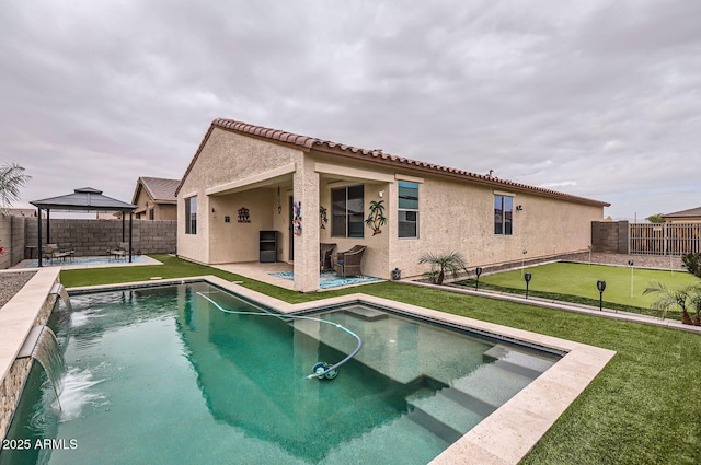 view of swimming pool with a fenced backyard, a patio, and a gazebo