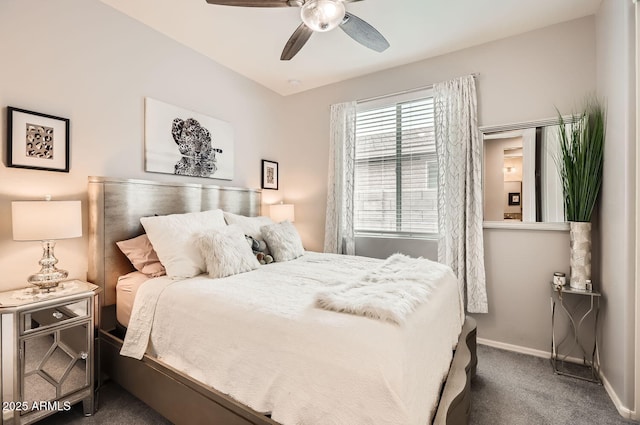 bedroom with dark colored carpet, a ceiling fan, and baseboards