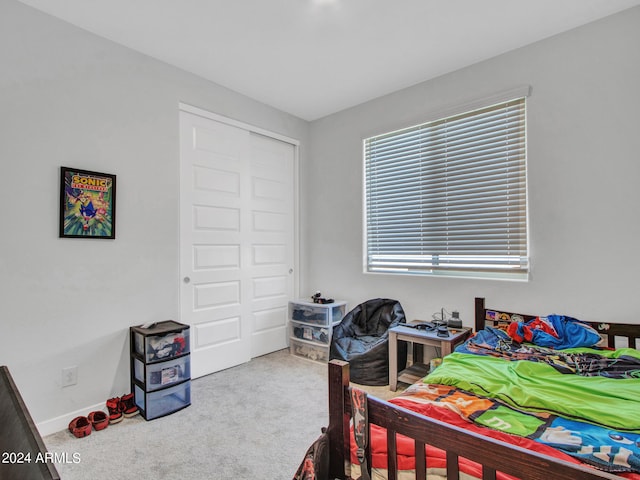 carpeted bedroom with a closet