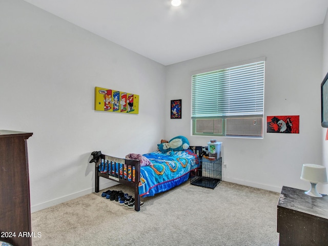 carpeted bedroom featuring baseboards