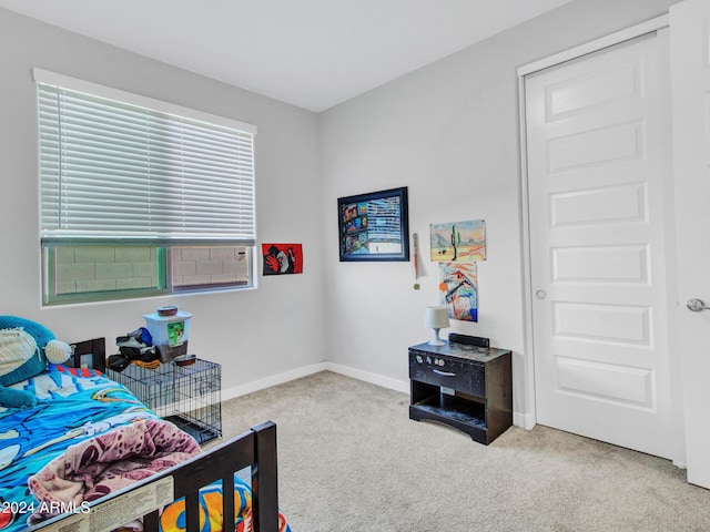 bedroom featuring baseboards and carpet